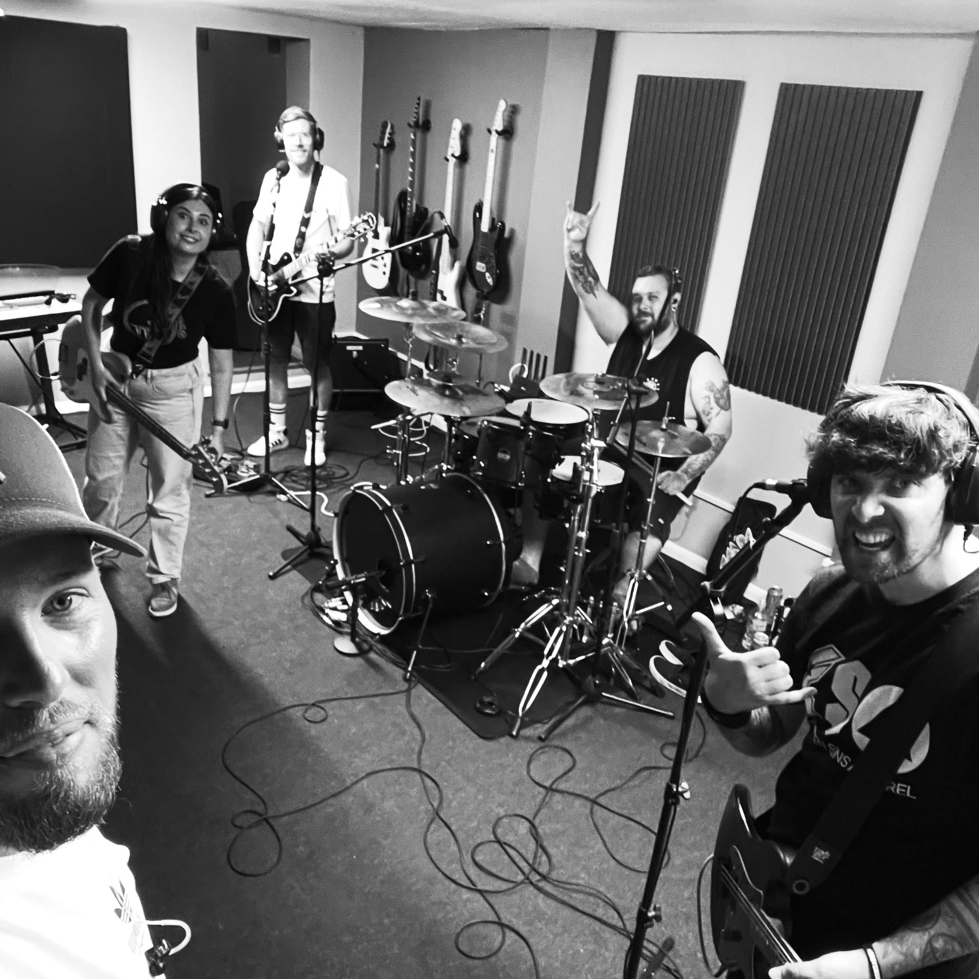 Black and white group portrait of a band in the studio