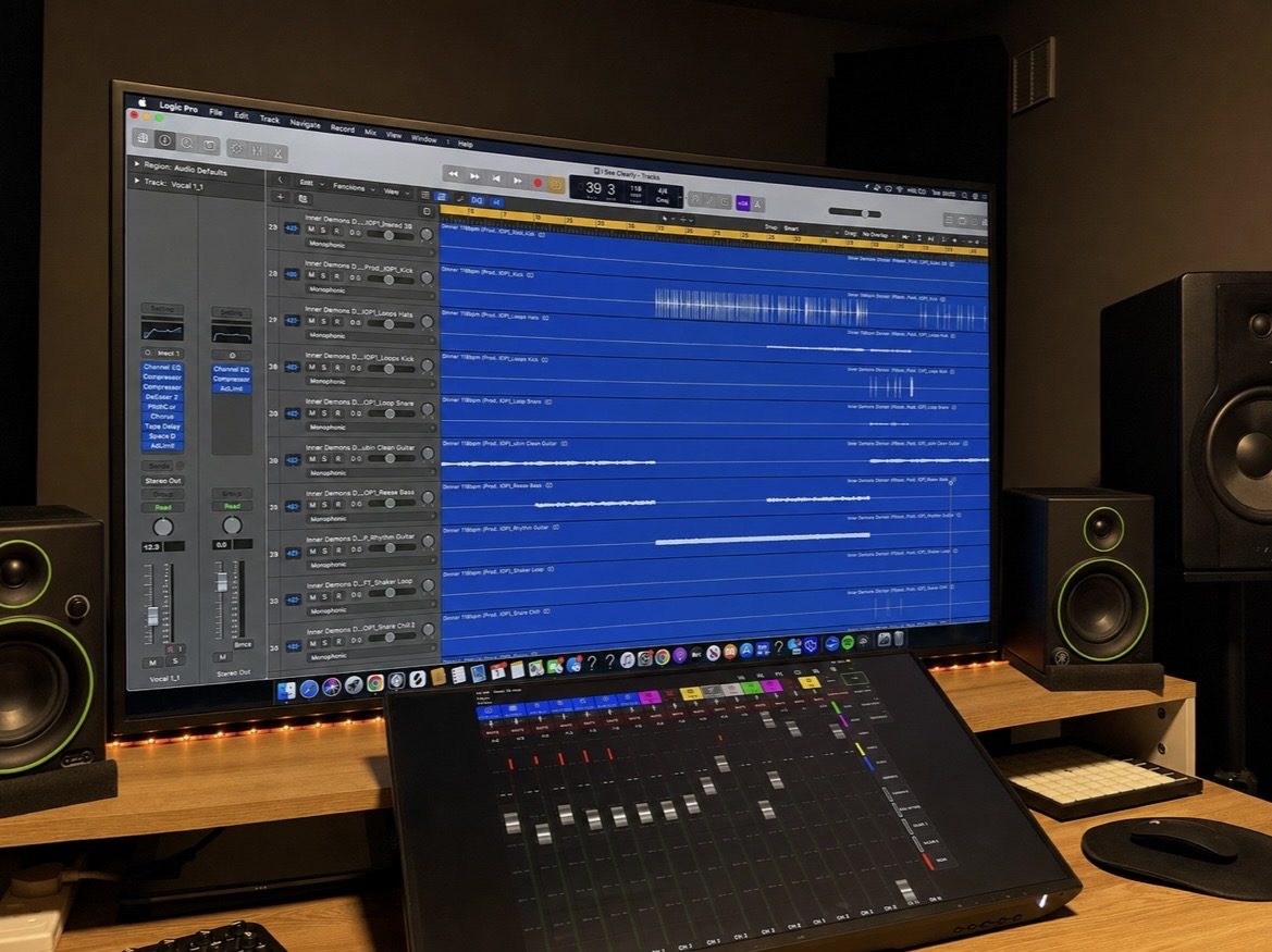 Control room desk with an active mix session, studio monitors and control surface