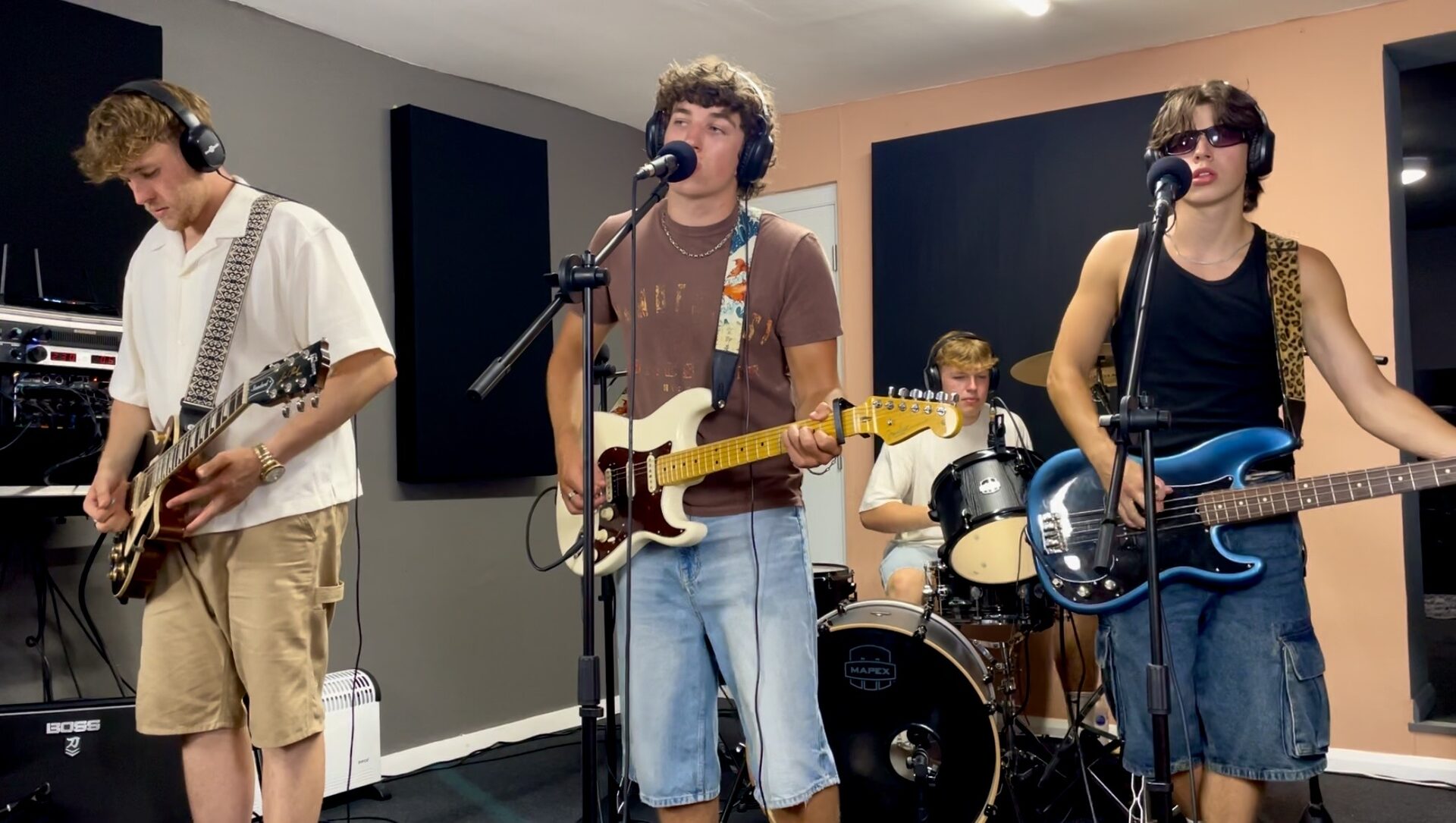 Full band performing together in the studio