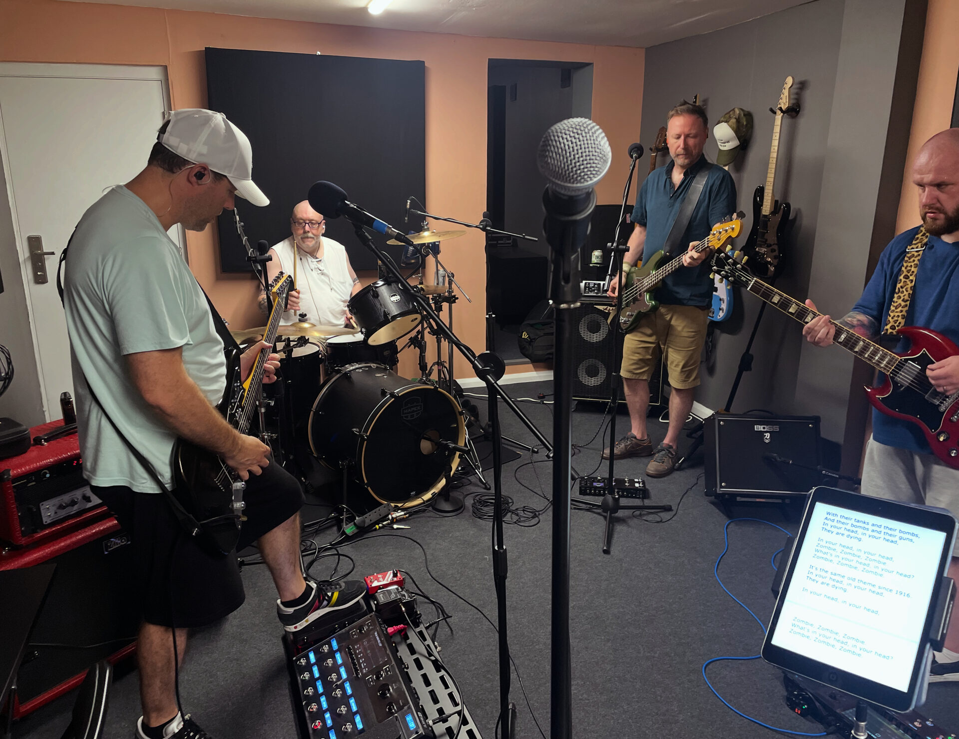 Four-piece band recording live in the studio
